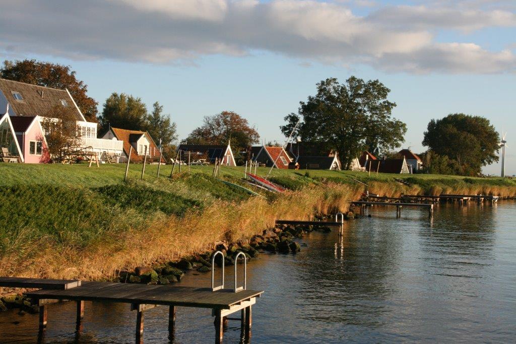 De weg door Uitdam langs bomen en water